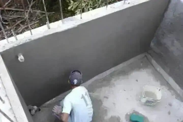 Worker applying anti-corrosive tank lining coating